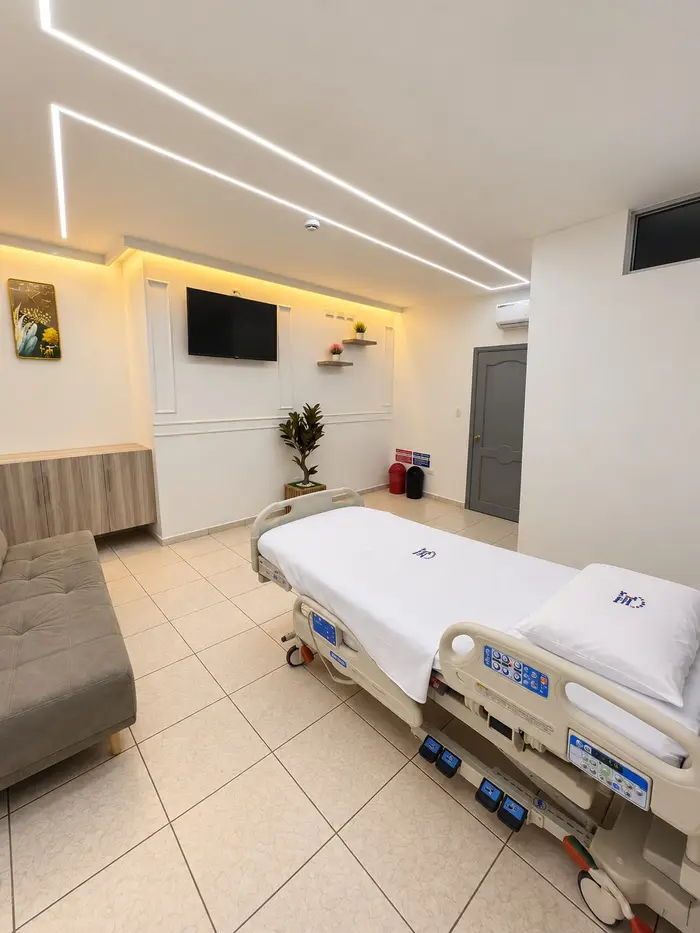La misma suite vista desde la entrada, con la cama y el televisor.